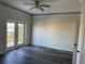 Bedroom featuring French doors to a deck, ceiling fan, and wood-look flooring at 2550 Bella Vista Dr, Davenport, FL 33897