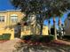 Attractive townhome with textured facade, brick path, mature landscaping, and a private courtyard entrance at 2550 Bella Vista Dr, Davenport, FL 33897