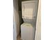 Efficient laundry space featuring a stacked washer and dryer unit, perfect for space-saving convenience at 2550 Bella Vista Dr, Davenport, FL 33897