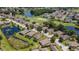 Aerial view of the neighborhood with ponds, manicured lawns, and mature trees enhancing curb appeal at 265 Del Sol Ave, Davenport, FL 33837