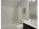 Bright bathroom features a shower-tub combo and modern vanity at 265 Del Sol Ave, Davenport, FL 33837