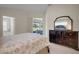 Light-filled bedroom with a sliding glass door to the backyard and a dark wood dresser at 265 Del Sol Ave, Davenport, FL 33837