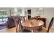 Warm dining room with seating for four and sliding glass doors to outside patio at 265 Del Sol Ave, Davenport, FL 33837