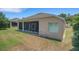 Exterior view of home featuring screened patio and well-maintained lawn at 265 Del Sol Ave, Davenport, FL 33837