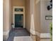 A covered front entryway showcasing a dark-colored door with sidelight and transom windows at 265 Del Sol Ave, Davenport, FL 33837