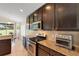 Gourmet kitchen featuring stainless steel appliances, sleek dark cabinetry, and tiled backsplash at 265 Del Sol Ave, Davenport, FL 33837