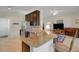Open kitchen with stainless steel appliances and granite countertops for easy entertaining at 265 Del Sol Ave, Davenport, FL 33837
