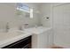 Well-lit laundry room includes a utility sink and modern washer and dryer at 265 Del Sol Ave, Davenport, FL 33837