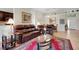 Spacious living room with a large leather sofa, tile flooring, and decorative accents at 265 Del Sol Ave, Davenport, FL 33837