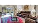 Comfortable living room featuring a leather sofa, a large rug, and sliding glass doors at 265 Del Sol Ave, Davenport, FL 33837