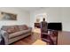 Cozy office area with a sofa, desk, comfortable chair, and hardwood floors at 265 Del Sol Ave, Davenport, FL 33837