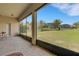 Enclosed patio with brick flooring provides tranquil views of the landscaped backyard at 265 Del Sol Ave, Davenport, FL 33837