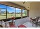 Relaxing enclosed patio features brick flooring and views of the green backyard at 265 Del Sol Ave, Davenport, FL 33837