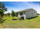 Backyard featuring well manicured lawn and grey stucco exterior at 317 Alexandrite St, Deland, FL 32720