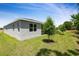 Backyard featuring well manicured lawn and grey stucco exterior at 317 Alexandrite St, Deland, FL 32720