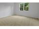 Bedroom featuring neutral carpet, a window, and white walls at 317 Alexandrite St, Deland, FL 32720