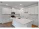 Bright kitchen with white cabinets, stainless steel appliances, and a large center island at 317 Alexandrite St, Deland, FL 32720