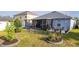 A lovely backyard with a screened lanai, manicured landscaping, and a charming patio set, perfect for outdoor relaxation at 3633 Bristol Cove Ln, St Cloud, FL 34772