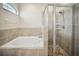 Bright bathroom showcasing separate tub and shower areas with modern tile and fixtures at 3633 Bristol Cove Ln, St Cloud, FL 34772