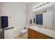 Well-lit bathroom features a vanity with a light wood finish and a framed mirror at 3633 Bristol Cove Ln, St Cloud, FL 34772