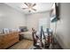 Bedroom with a gray bed, mounted TV, ceiling fan and a gaming chair at 3633 Bristol Cove Ln, St Cloud, FL 34772