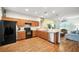 Open kitchen with wood cabinets, stainless steel appliances, and an easy transition into the living area at 3633 Bristol Cove Ln, St Cloud, FL 34772
