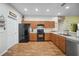 Well-equipped kitchen featuring wood cabinets, laminate floors, and modern appliances at 3633 Bristol Cove Ln, St Cloud, FL 34772