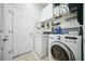 Efficient laundry room equipped with modern washer and dryer, ample storage, and convenient shelving at 3633 Bristol Cove Ln, St Cloud, FL 34772
