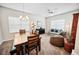 Open-concept living and dining area with neutral tones, large windows, and ceiling fan at 3633 Bristol Cove Ln, St Cloud, FL 34772