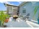 Outdoor patio area with modern seating around a cozy fire pit and decorative plants at 3633 Bristol Cove Ln, St Cloud, FL 34772