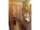 Cozy bathroom featuring a shower, toilet, and vanity with storage at 406 E Grove Ave, Lake Wales, FL 33853
