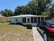 Charming single-story home with a well-maintained front yard and mature trees in a peaceful neighborhood at 406 E Grove Ave, Lake Wales, FL 33853