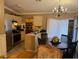 Cozy eat-in kitchen features stainless steel appliances and a chandelier over the dining table at 406 E Grove Ave, Lake Wales, FL 33853