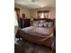 Comfortable main bedroom with soft lighting, a plush bed, and neutral decor at 406 E Grove Ave, Lake Wales, FL 33853