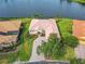 Beautiful lakefront home with mature landscaping, paver driveway, and terra cotta roof offering serene water views at 644 Shorehaven Dr, Kissimmee, FL 34759