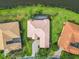 Overhead shows a home with a screened-in patio and lush landscaping adjacent to a waterfront at 644 Shorehaven Dr, Kissimmee, FL 34759