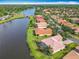 Aerial shot with a picturesque lakeside community with terra cotta roofs and manicured lawns at 644 Shorehaven Dr, Kissimmee, FL 34759