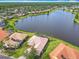 Stunning lakefront property with lush landscaping, mature trees, and terra cotta tile roof in a beautiful lakeside community at 644 Shorehaven Dr, Kissimmee, FL 34759