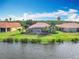 Back of house aerial view of house with screened in lanai and water view at 644 Shorehaven Dr, Kissimmee, FL 34759