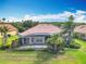 Aerial view of home showcasing a screened-in lanai and well-maintained landscaping at 644 Shorehaven Dr, Kissimmee, FL 34759