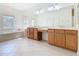 Bathroom featuring tile flooring, soaking tub, and dual sinks with vanity area at 644 Shorehaven Dr, Kissimmee, FL 34759