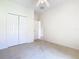 Inviting bedroom with neutral carpet, a ceiling fan, closet, and a doorway to other areas of the home at 644 Shorehaven Dr, Kissimmee, FL 34759