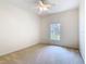 Bright bedroom with neutral carpet, ceiling fan, and a large window that fills the space with natural light at 644 Shorehaven Dr, Kissimmee, FL 34759