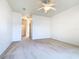 Neutral carpet in a bedroom with a ceiling fan and hallway access at 644 Shorehaven Dr, Kissimmee, FL 34759