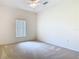 Comfortable bedroom with neutral carpet, a ceiling fan, and a window providing ample natural light at 644 Shorehaven Dr, Kissimmee, FL 34759