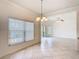 Bright dining room with a hanging chandelier and a view of the lake at 644 Shorehaven Dr, Kissimmee, FL 34759