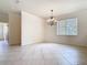 Open dining area featuring neutral walls, tiled floors, a chandelier, and natural light at 644 Shorehaven Dr, Kissimmee, FL 34759