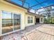 Rear of the home shows windows and sliding doors opening to a screened-in lanai at 644 Shorehaven Dr, Kissimmee, FL 34759