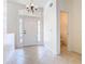 Bright foyer with tiled flooring, a chandelier, and a view into the adjacent powder room at 644 Shorehaven Dr, Kissimmee, FL 34759