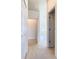 Hallway featuring neutral carpet, doors, and access to a bedroom at 644 Shorehaven Dr, Kissimmee, FL 34759